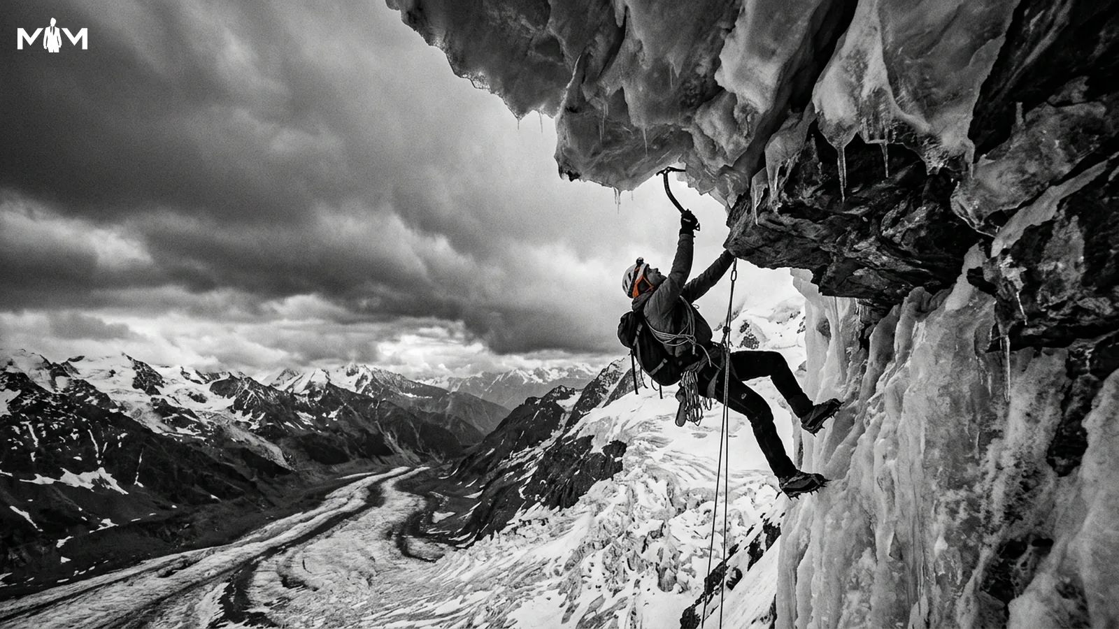 Ice climber on a fragile overhanging ledge high above a glacier gripping a single ice axe dramatic