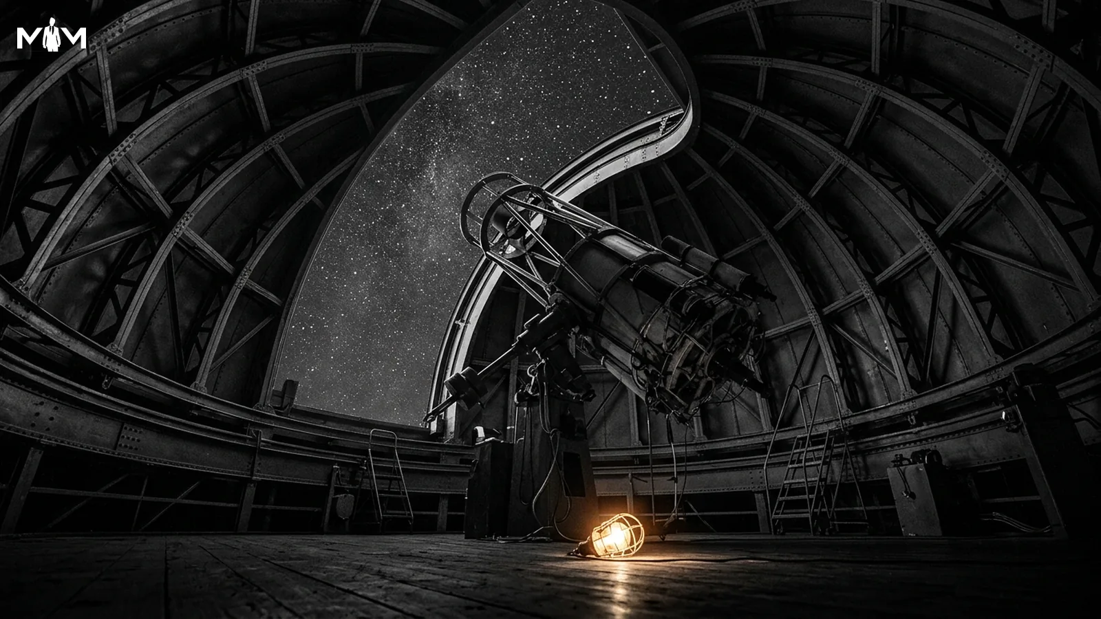 Observatory dome with large telescope aimed upward through the open slit toward a star filled night